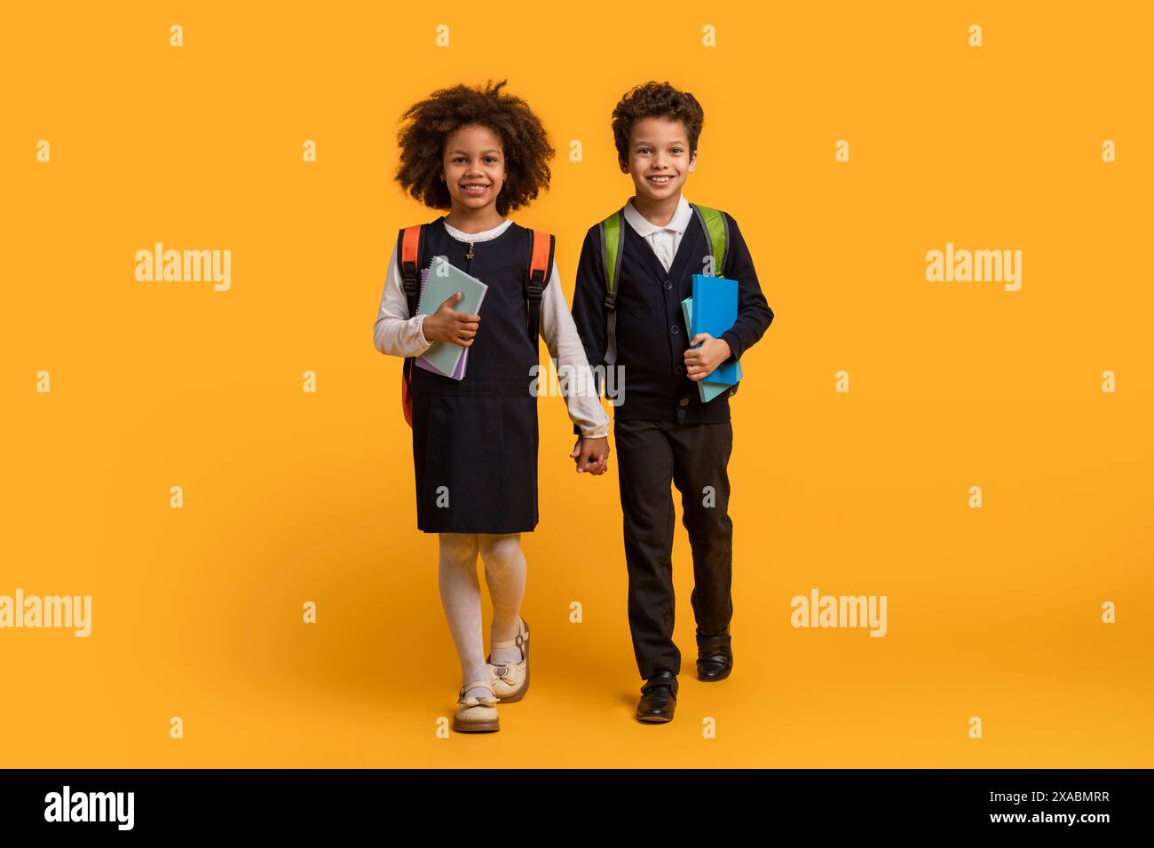 Girl boy walking books hi-res stock photography and images - Alamy