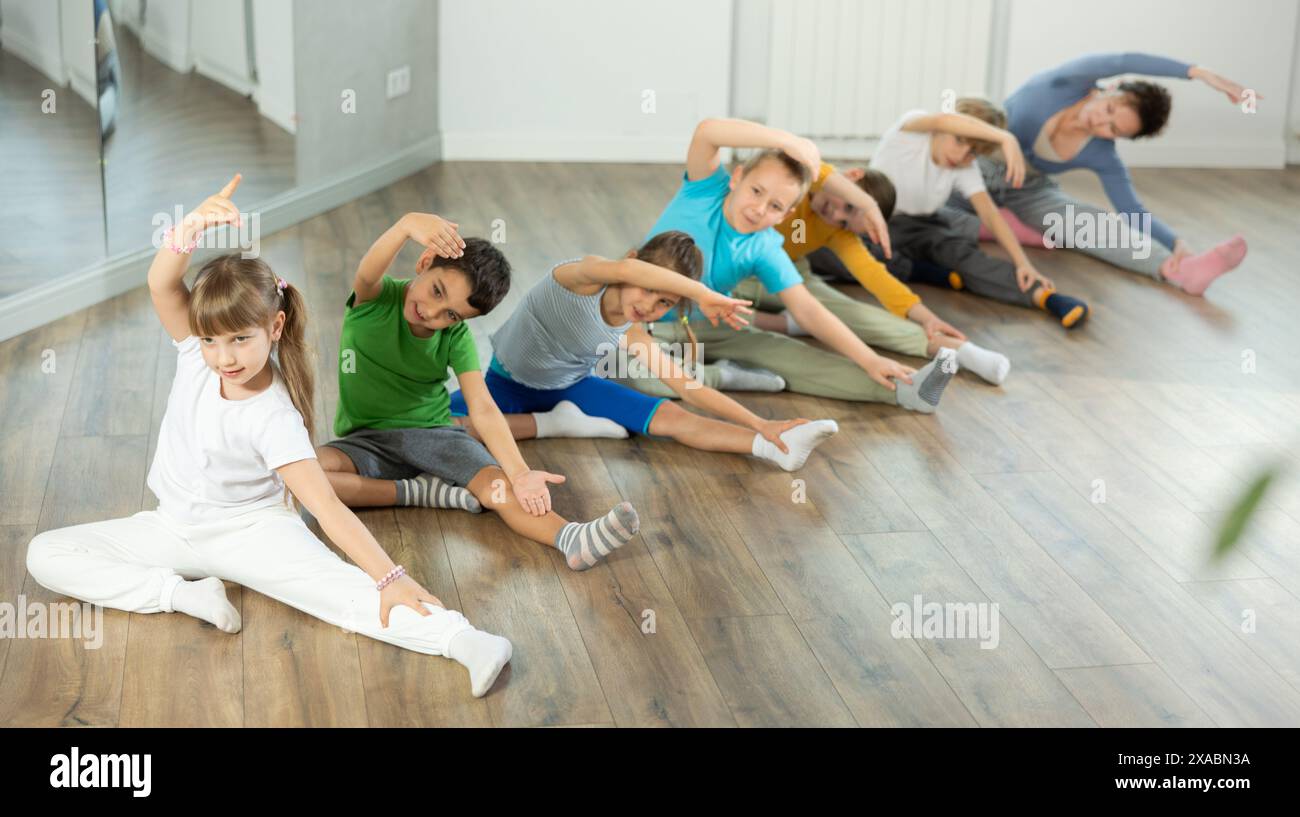 Group of children warming up before dance class Stock Photo