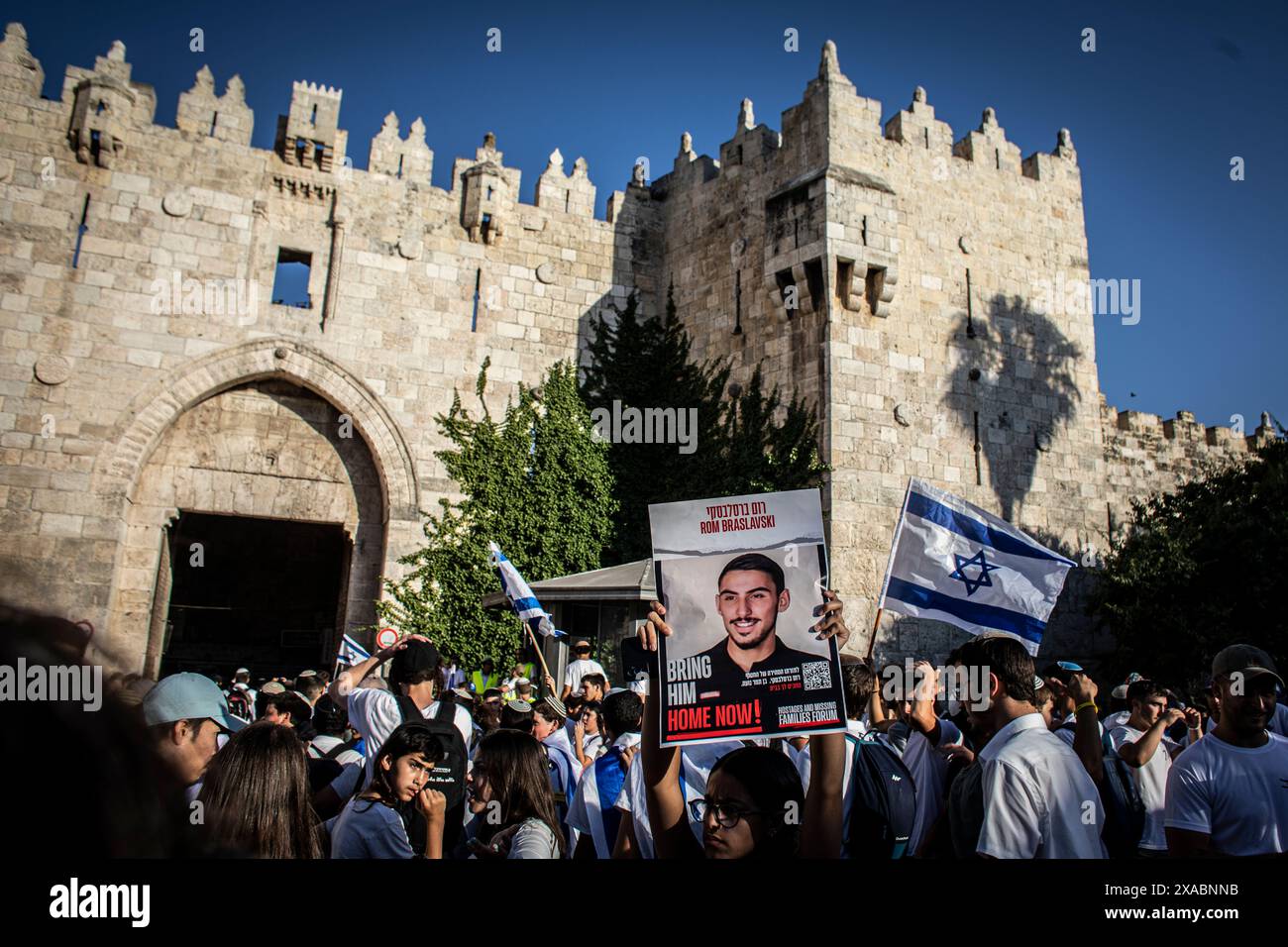 An Israeli woman holds up a placard showing photo of Rom Braslavsky who is held hostage by Hamas in Gaza outside Damascus gate In Jerusalem, Thursday June 5 2024. Tens of thousands of young religious Ultra nationalists Zionist men and women, have paraded through Muslim parts of the Old City of Jerusalem in the annual Jerusalem day Flag march, an event that threatens to trigger further violence in the Israel-Hamas war. Jerusalem day marks the reunification of the city during the Six Day War and IsraelÕs capture of the Temple Mount and the Western Wall, JudaismÕs holiest sites. Photo by Eyal War Stock Photo