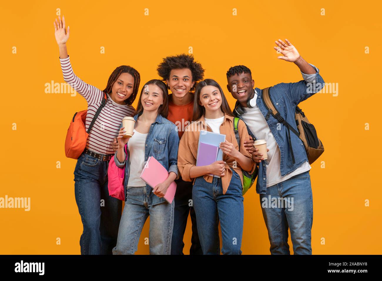 Diverse Group of Students Smiling and Waving Stock Photo