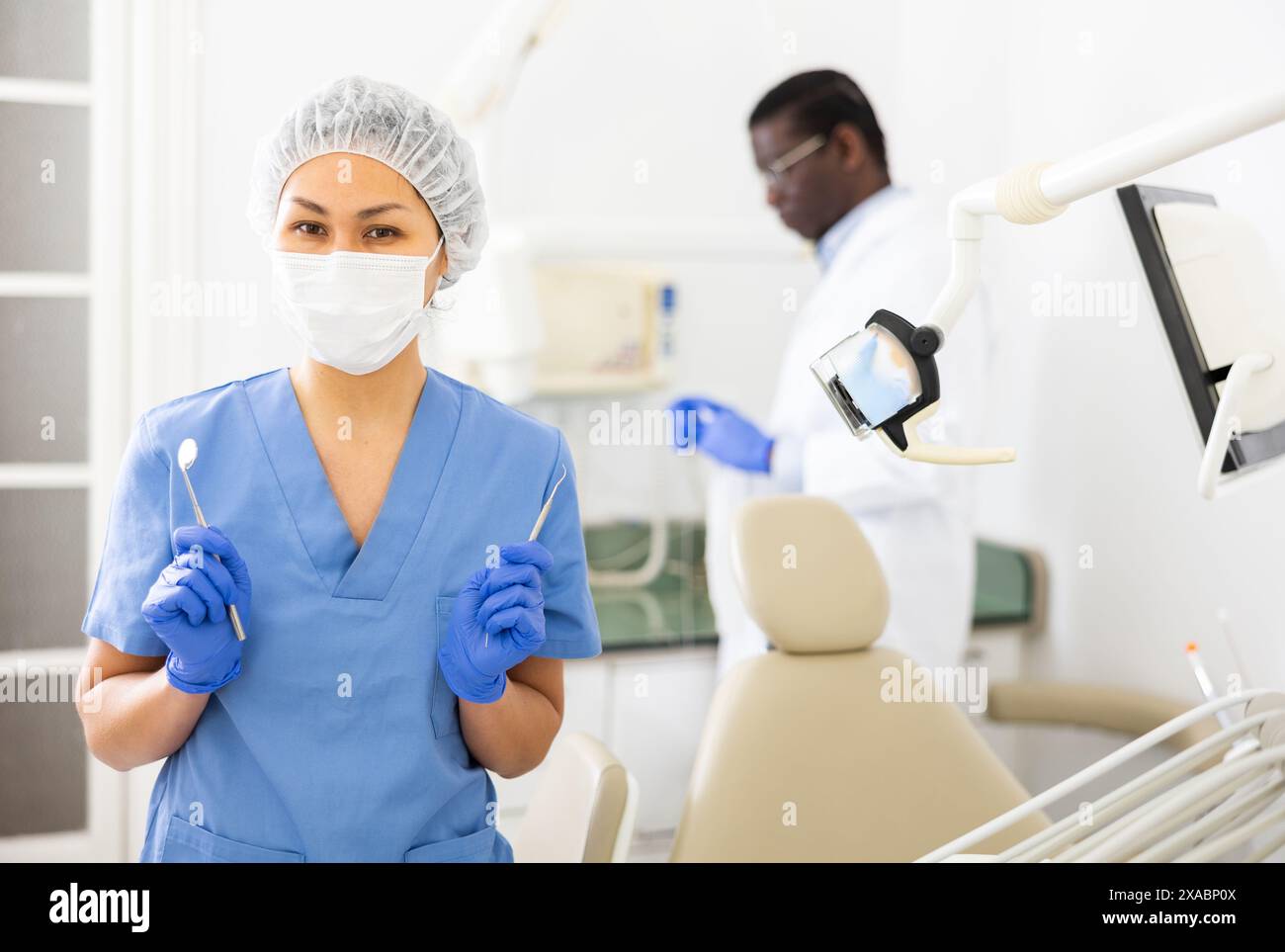 Portrait of a nurse with tools in her hands and wearing a medical mask