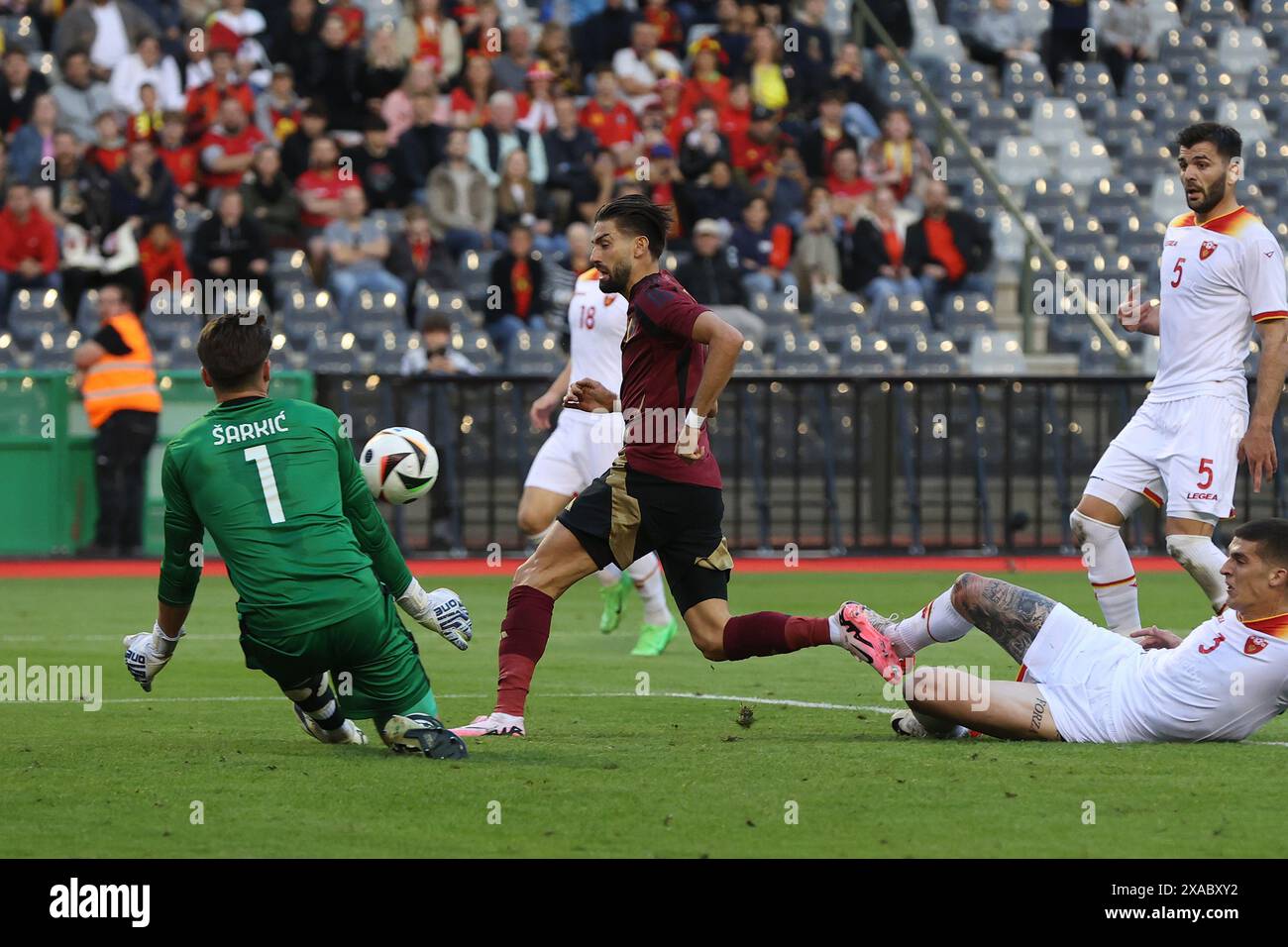Brussels, Belgium. 5th June, 2024. Montenegro's goalkeeper Matija Sarkic (1st L) makes a save against Yannick Carrasco (2nd L) of Belgium during a friendly match between Belgium and Montenegro in Brussels, Belgium, June 5, 2024. Credit: Zhao Dingzhe/Xinhua/Alamy Live News Stock Photo