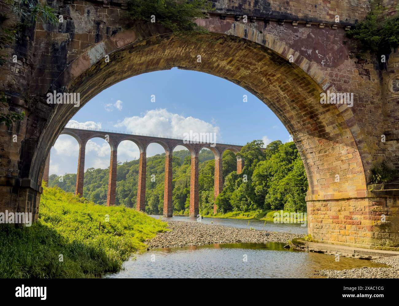 Drygrange, UK. 05th June, 2024. 5th June 2024 Weather. A view looking towards the tall red sandstone arches of Lederfoot Viaduct which spans the River Tweed near Melrose, juxtaposed with one of the large arches of the attractive old Drygrange Bridge that dates from 1780 was designed by Scottish architect and engineer, Alexander Stevens. Its central span of 31 metres was exceptional for its time. A Roman bridge did at one time cross the Tweed at Leaderfoot near Newstead, conveying the Roman Dere Street north from the fort at Trimontium. Picture, Credit: phil wilkinson/Alamy Live News Stock Photo