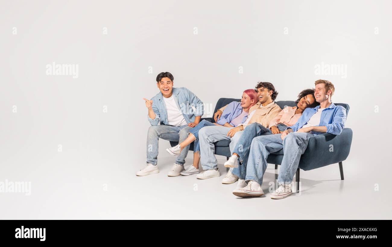 Smiling Diverse Friends Enjoying Time Together On Sofa Stock Photo