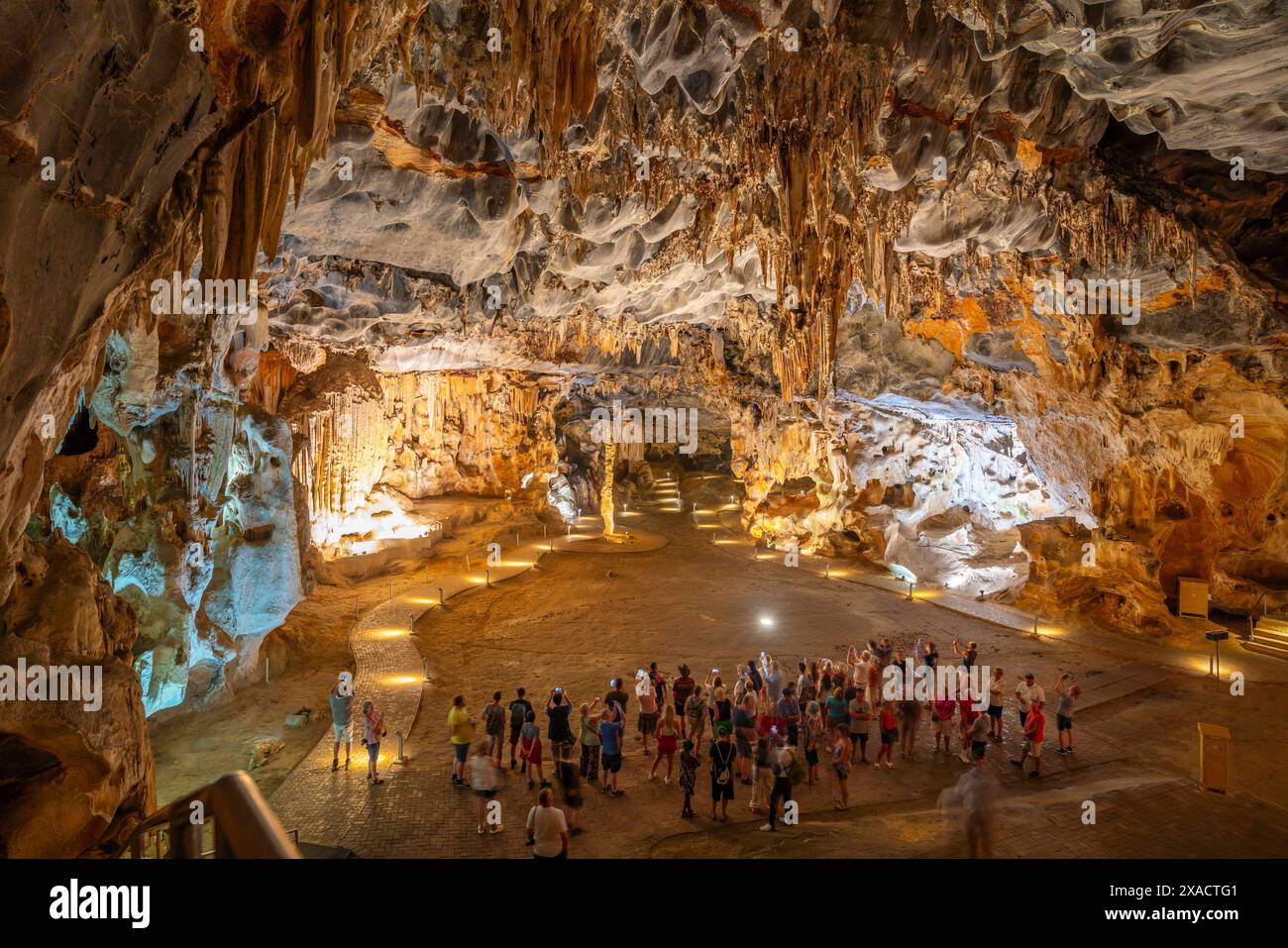 View Of Visitors Viewing Stalagmites And Stalactites In The Interior Of 
