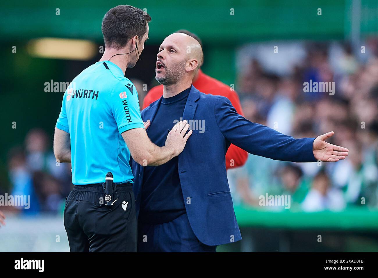 Referee Iosu Galech Apezteguia and Real Racing Club head coach Jose