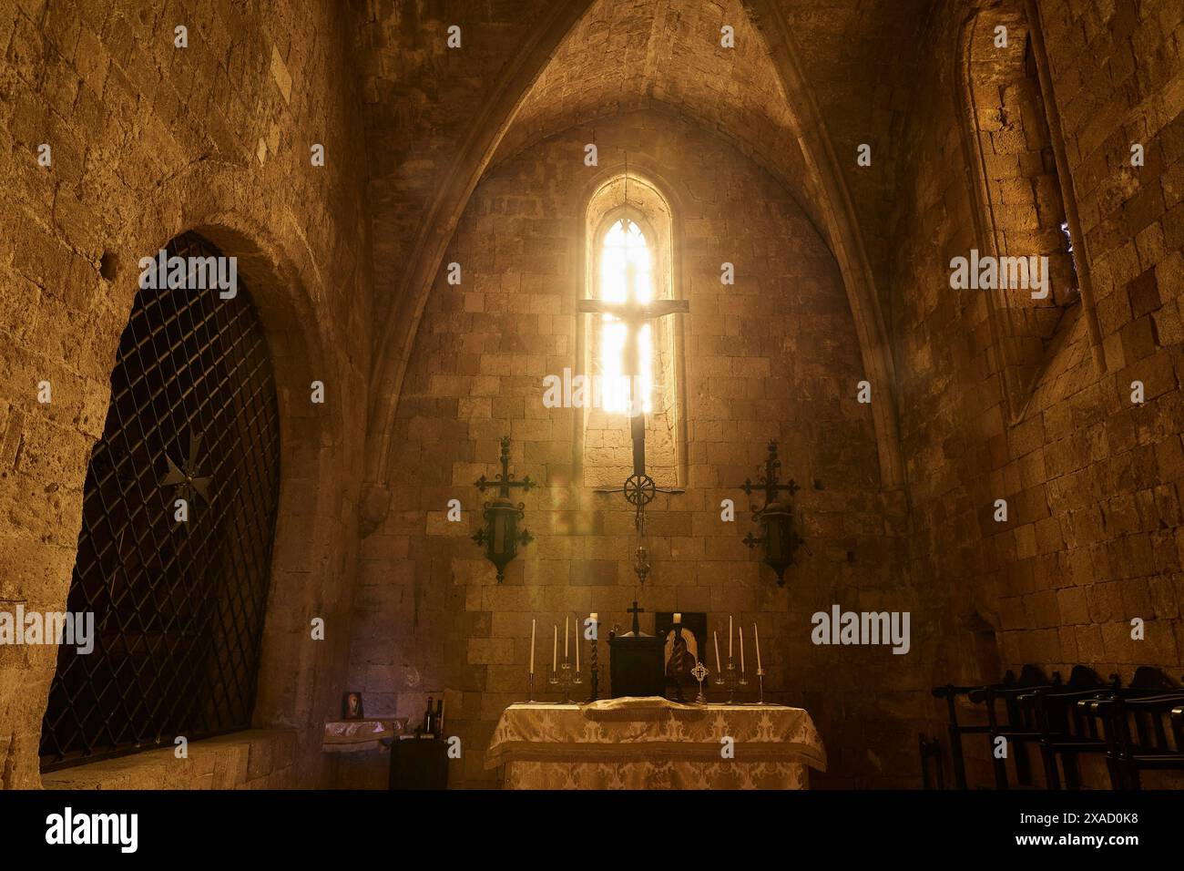 Chancel of the monastery church, interior of a church with illuminated altar and Gothic window, Monastery of Our Lady of Mount Filerimos, Filerimos Stock Photo