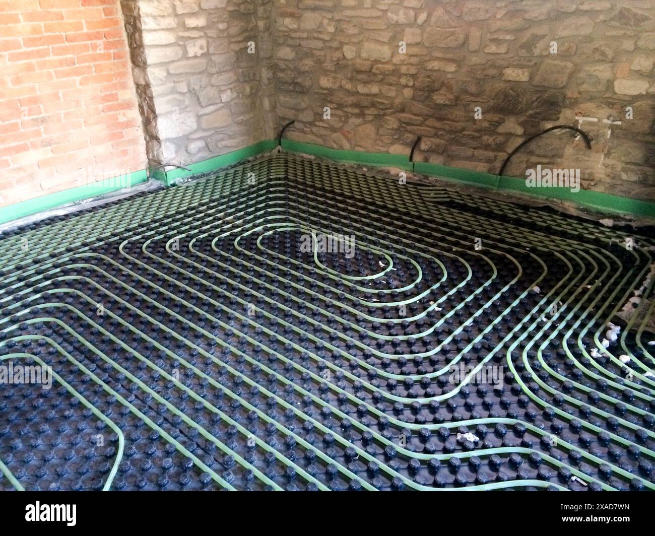 installation of underfloor heating system with laying of pipes in a ...