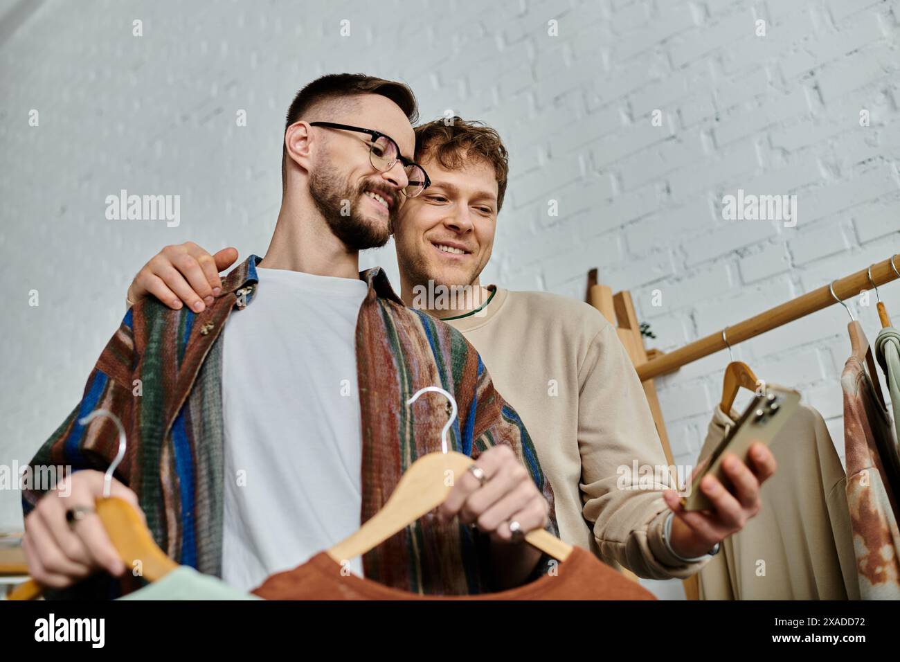 Two men, partners in love and design, stand side by side in a designer