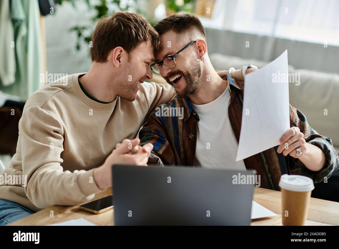 Two Guys Working Two men in designer workshop, working together on laptop Stock Photo ...