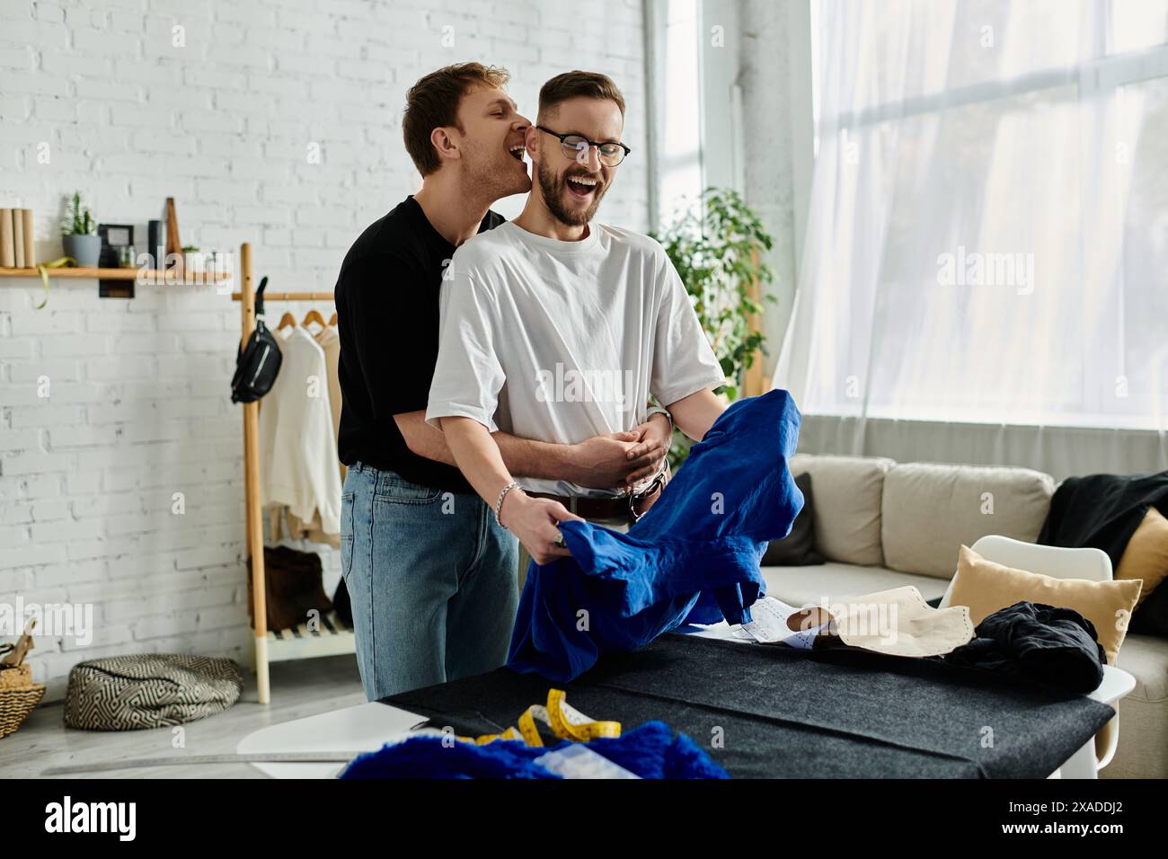 Two men, creatively collaborating in their stylish atelier Stock Photo