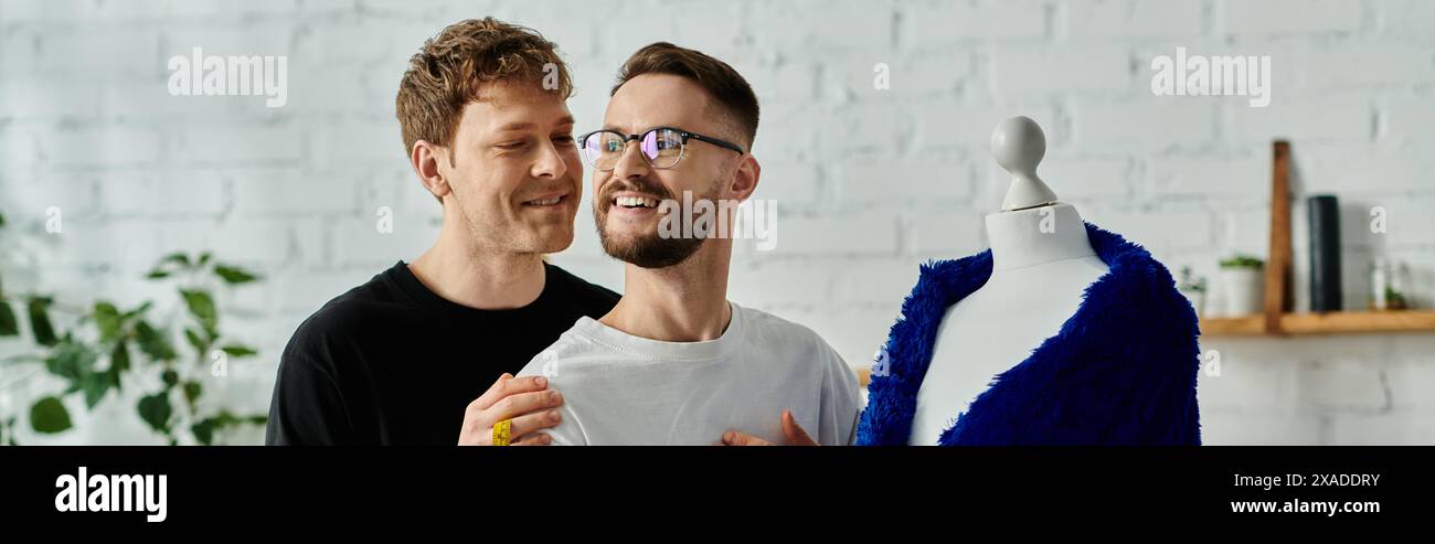 Two men with a mannequin in a designer workshop. Stock Photo