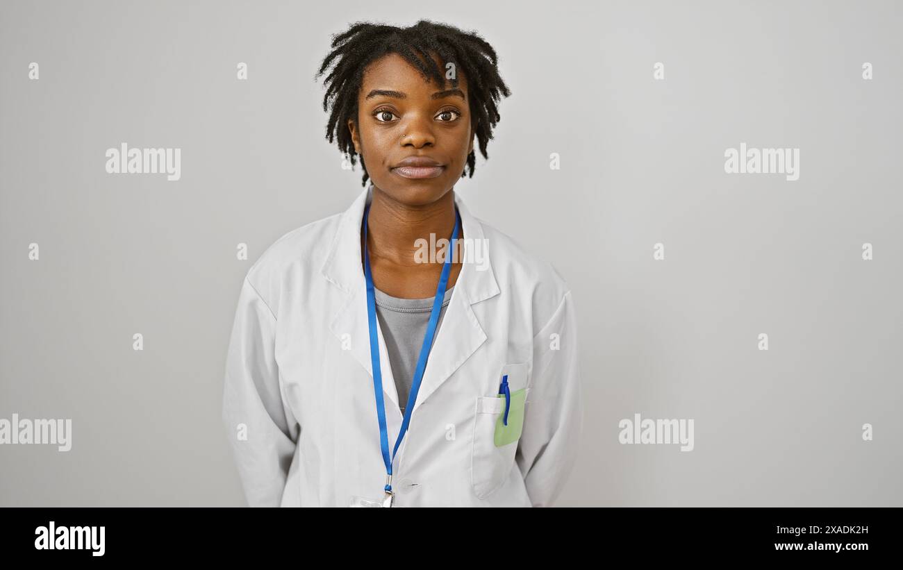 Young african woman with dreadlocks dressed in lab coat against white ...