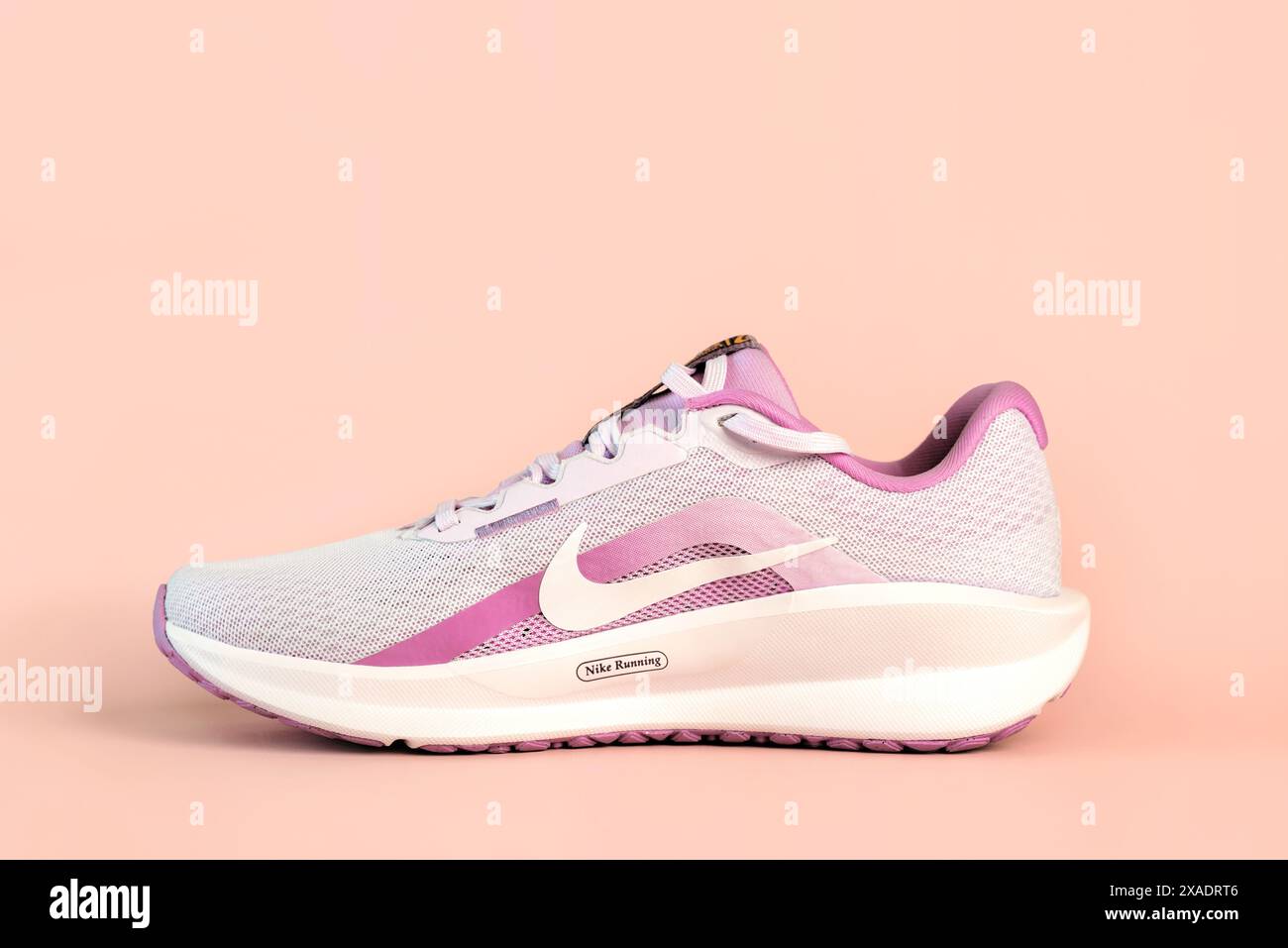 Nike Downshifter 13 Women's Road Running Shoe over pink background Stock Photo