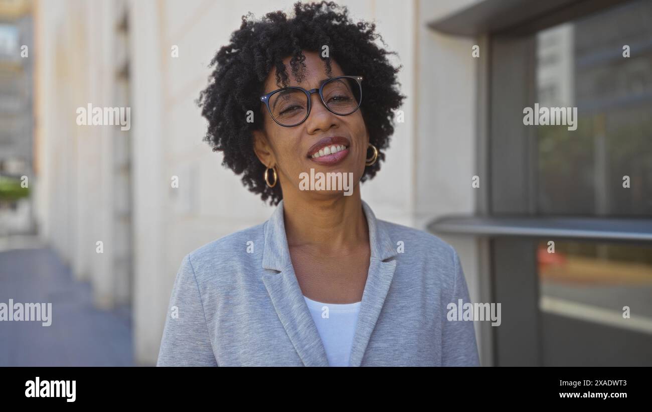 A beautiful young african american woman with curly hair wearing ...