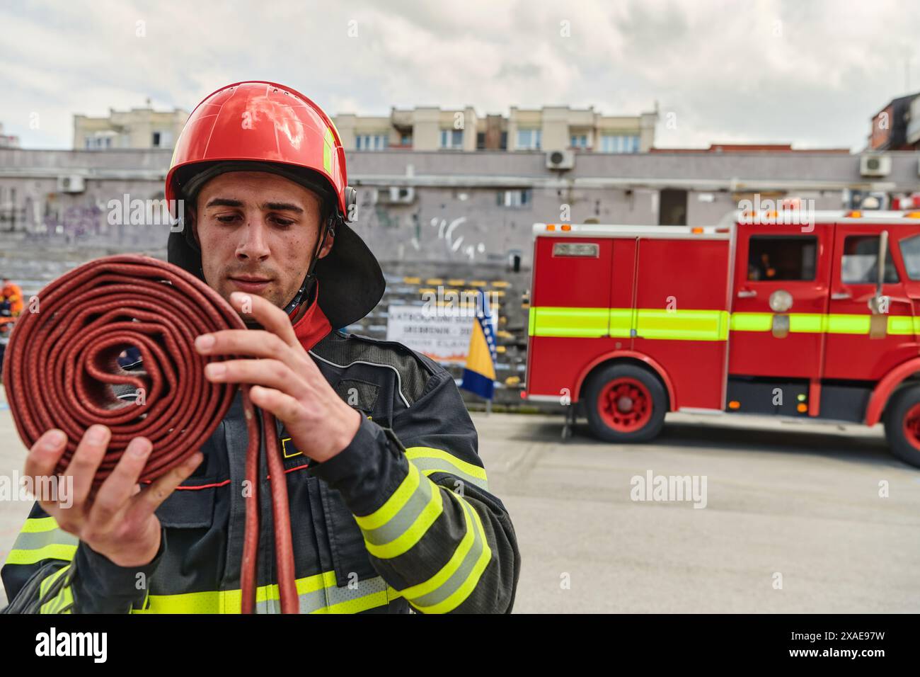 Professional Firefighter Cleaning Up Fire Hose After Extinguishing ...