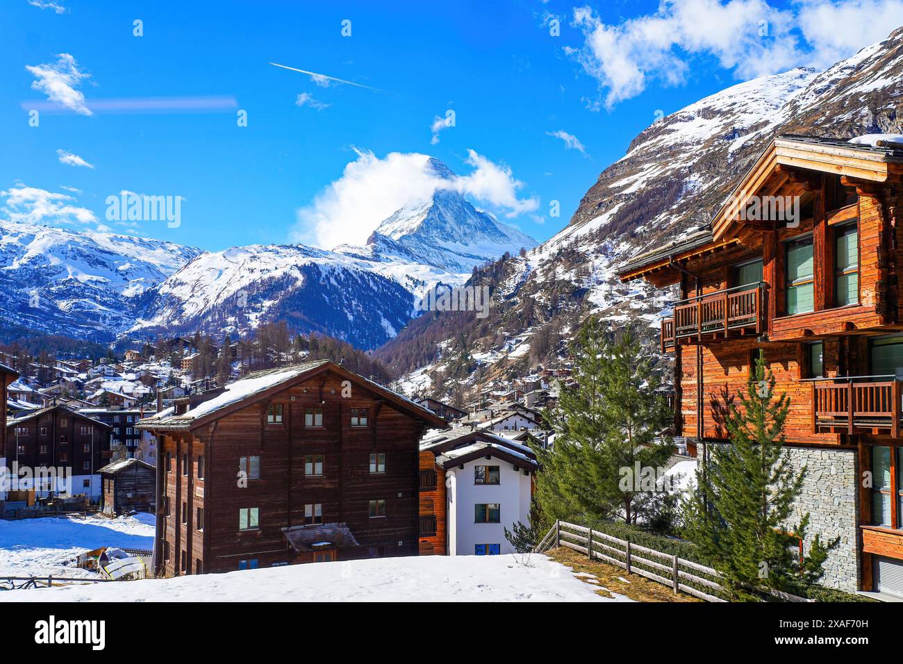 Wooden chalets in the village of Zermatt overlooked by the Matterhorn ...