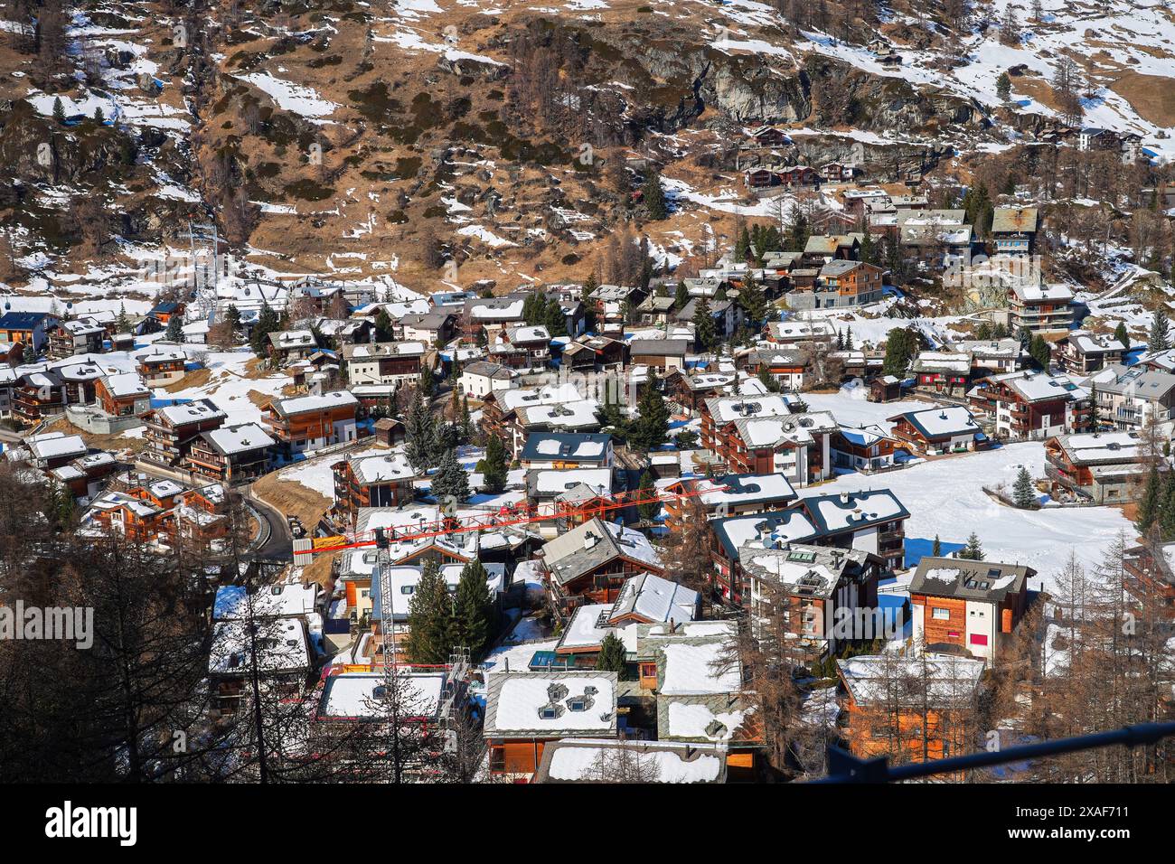 Snow-covered rooftops of Zermatt in the Swiss Alps in winter - Idyllic ...
