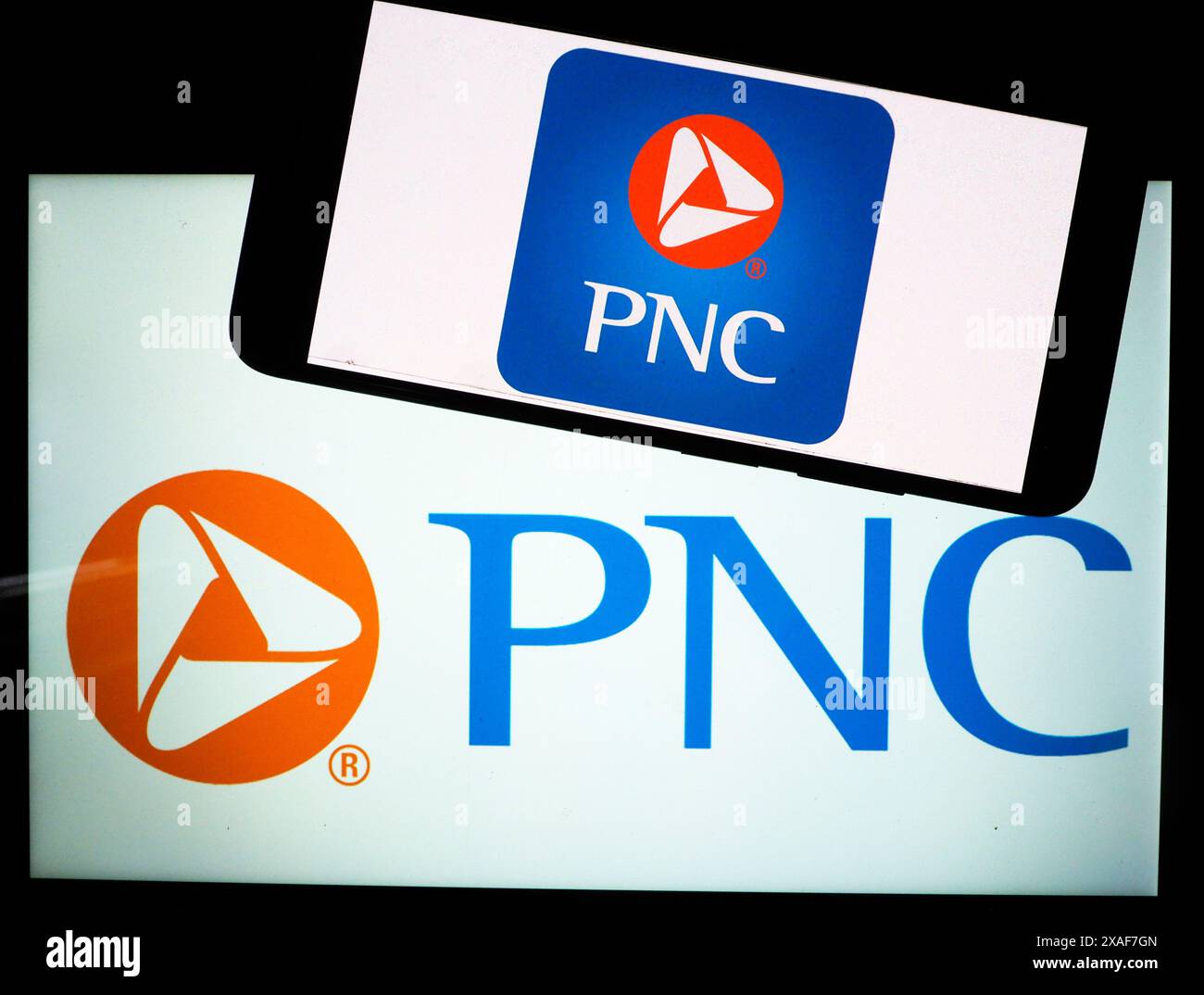 In this photo illustration, a PNC Financial Services Group logo seen displayed on a tablet Stock