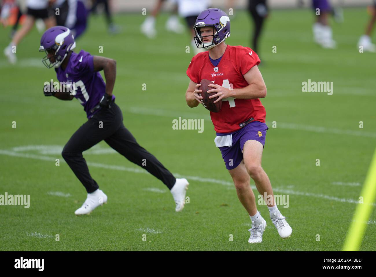 Minnesota Vikings quarterback Sam Darnold, right, takes part in drills
