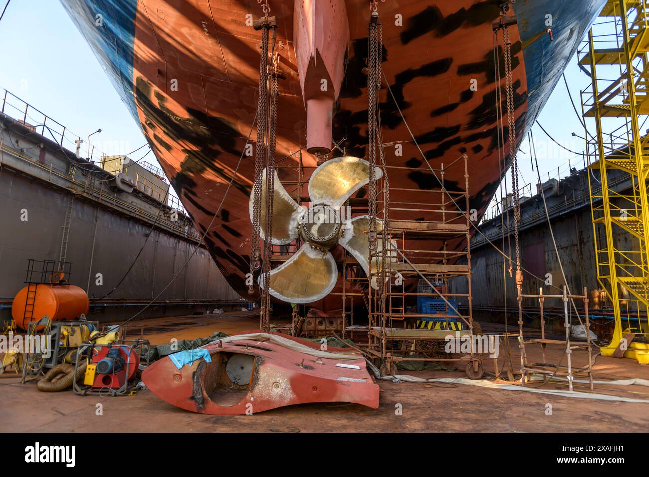 Cargo vessel in dry dock on ship repairing yard. Variable pitch ...