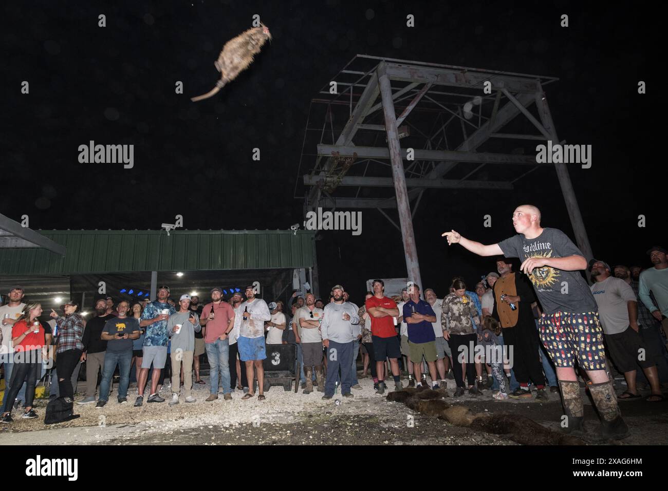 Participant hurls a dead nutria in the 