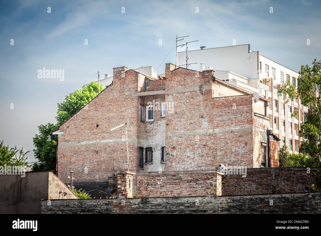 This image captures a damaged facade of a residential building in the