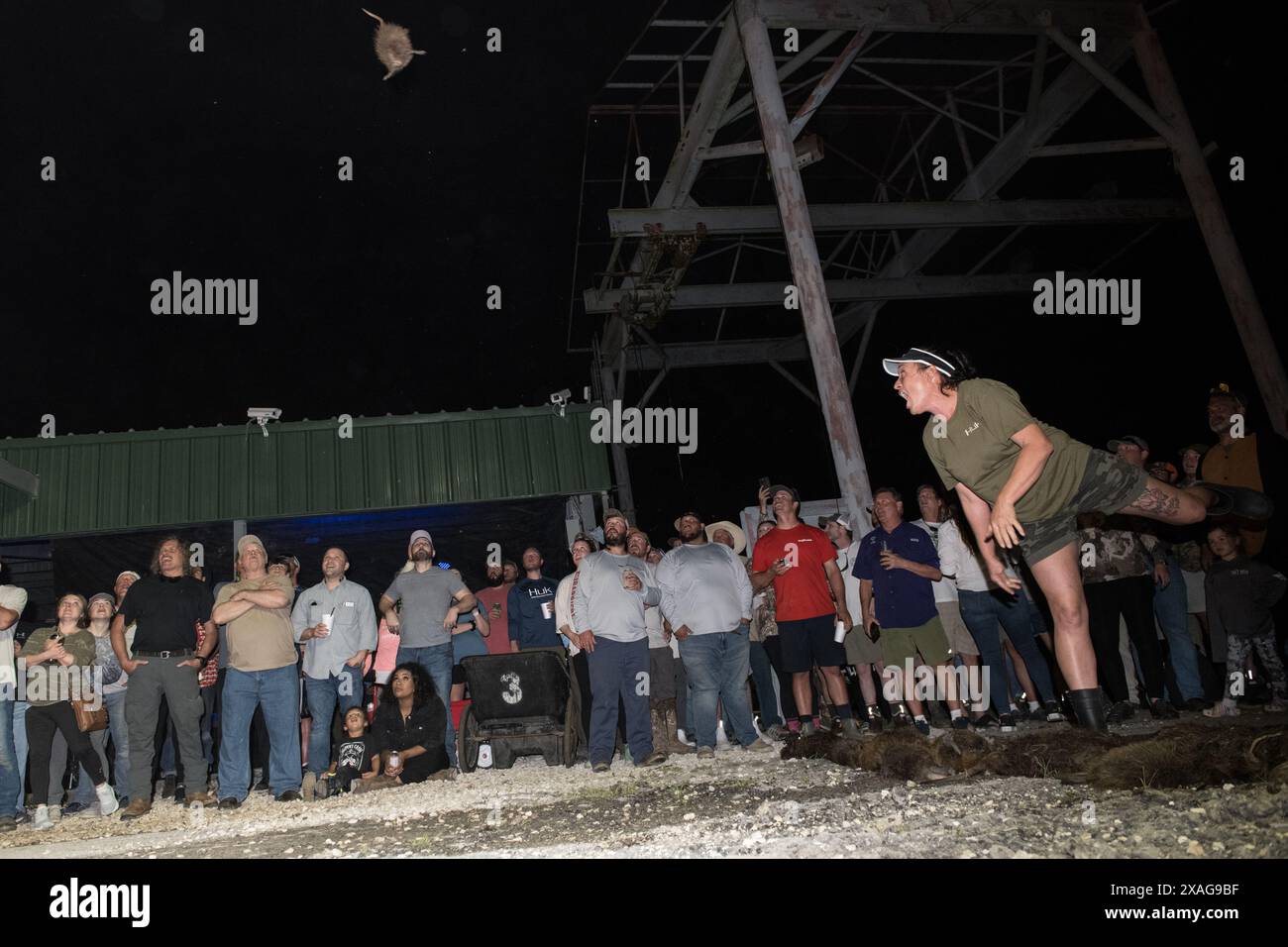 Rodent Rodeo Participant hurls a dead nutria in the