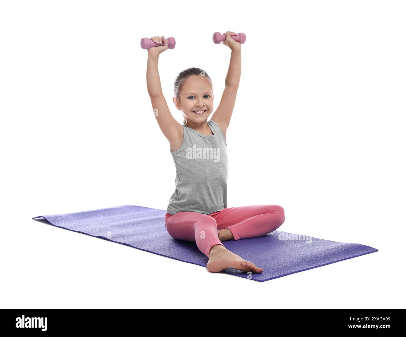 Cute little girl with dumbbells on white background Stock Photo - Alamy
