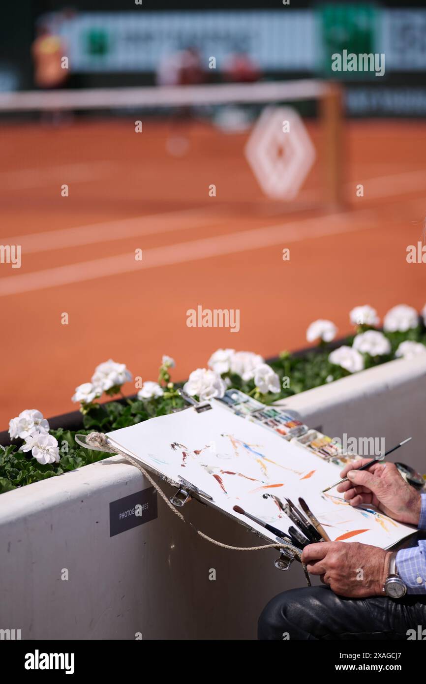 Paris, France. 6th June, 2024. A man draws a piture during the women's singles semifinal match between Coco Gauff of the United States and Iga Swiatek of Poland at the French Open tennis tournament at Roland Garros in Paris, France, on June 6, 2024. Credit: Meng Dingbo/Xinhua/Alamy Live News Stock Photo