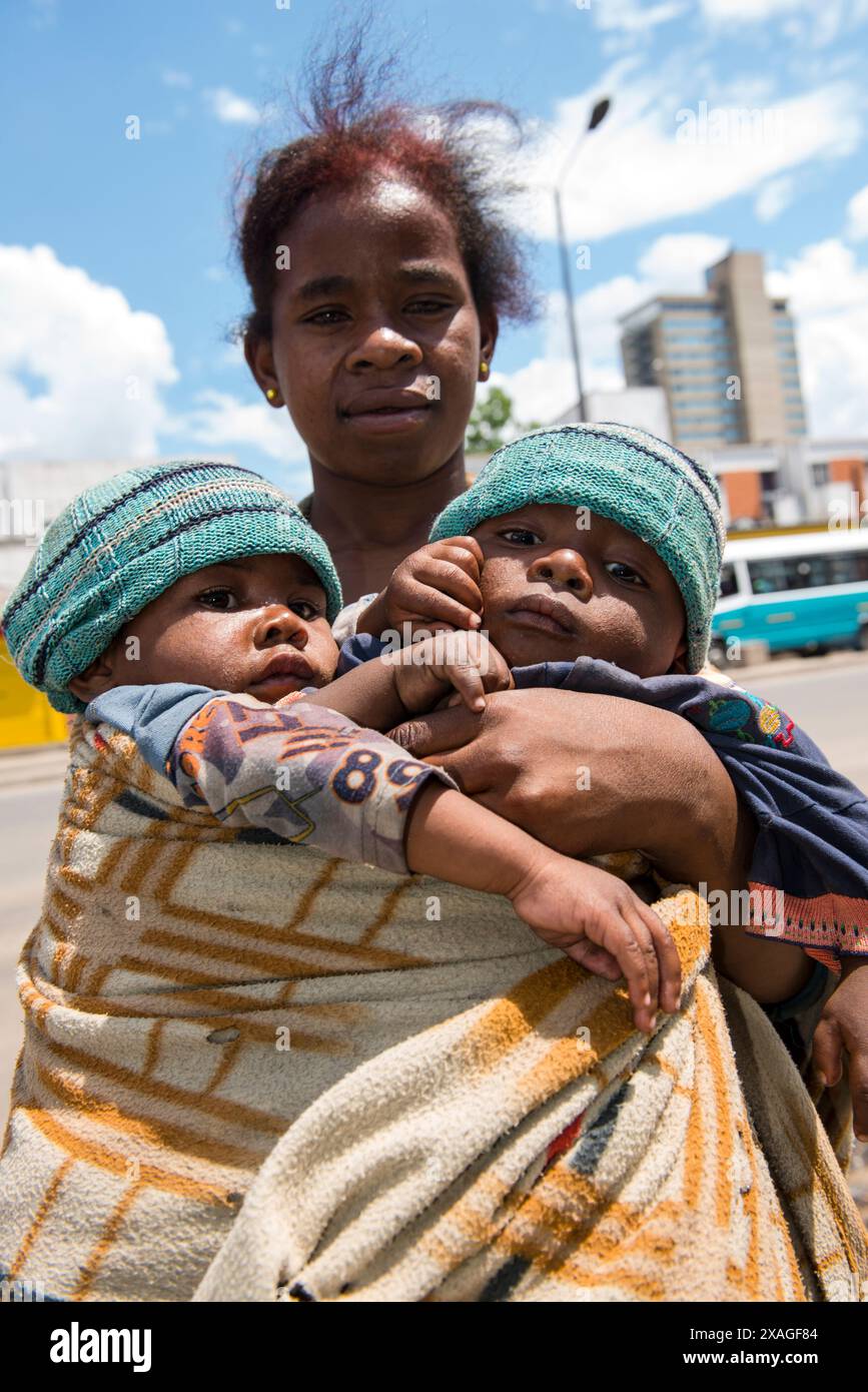 A Malagasy woman carrying her twins boys. Antananarivo, Madagascar