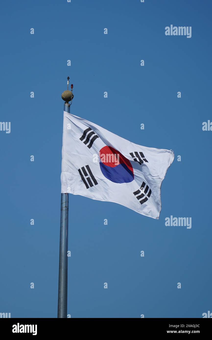 National flag of South Korea waving in the wind on blue sky background Stock Photo