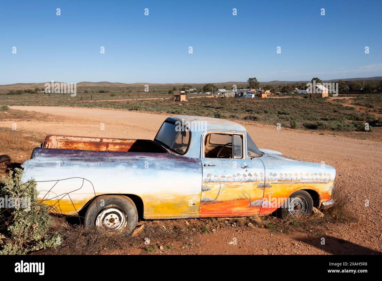 Old abandoned car with a desert scene painted on the side in Silverton ...
