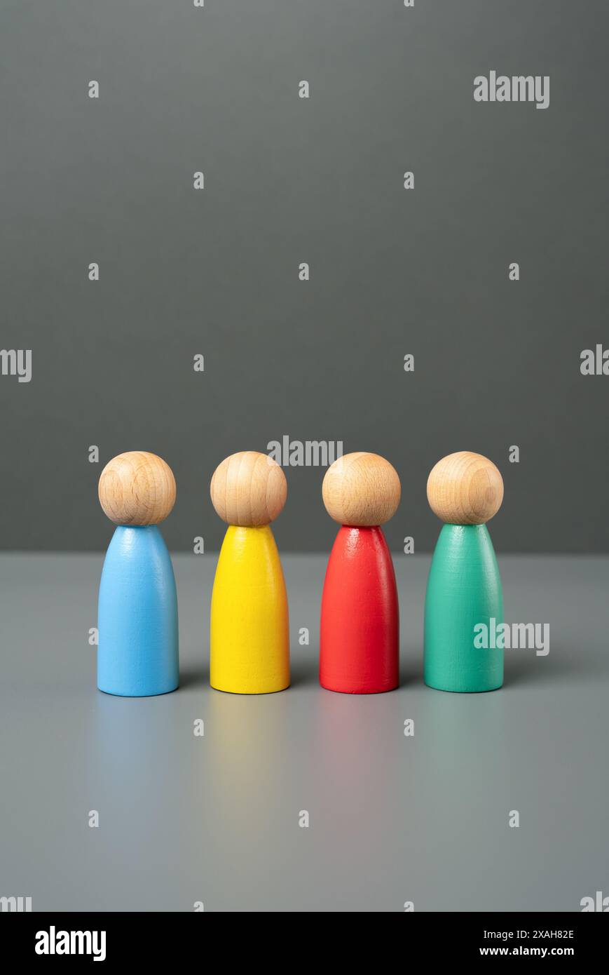 Multi-colored people figures. People representing different groups, communities and cultures. Consumer groups, their preferences and purchasing power. Stock Photo