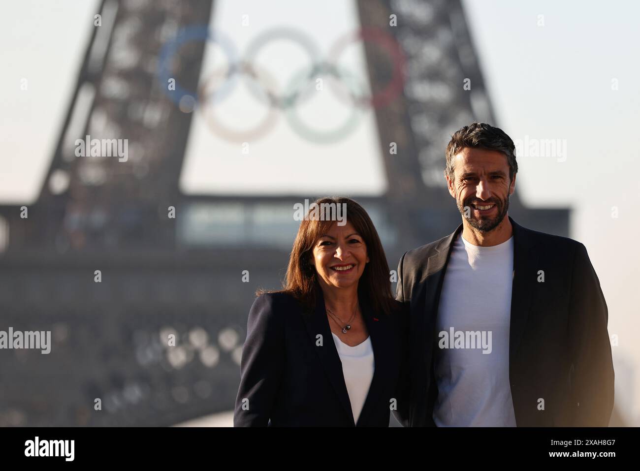 Paris, France. 7th June, 2024. President of the Paris 2024 Olympic Games Organizing Committee Tony Estanguet (R) and Paris Mayor Anne Hidalgo pose with the Olympic rings on the Eiffel Tower, in Paris, France, on June 7, 2024. The Olympics rings are unveiled on the Eiffel Tower early in the morning of Friday as the French capital marks 50 days until the start of the upcoming Paris 2024 Olympic Games. Credit: Gao Jing/Xinhua/Alamy Live News Stock Photo