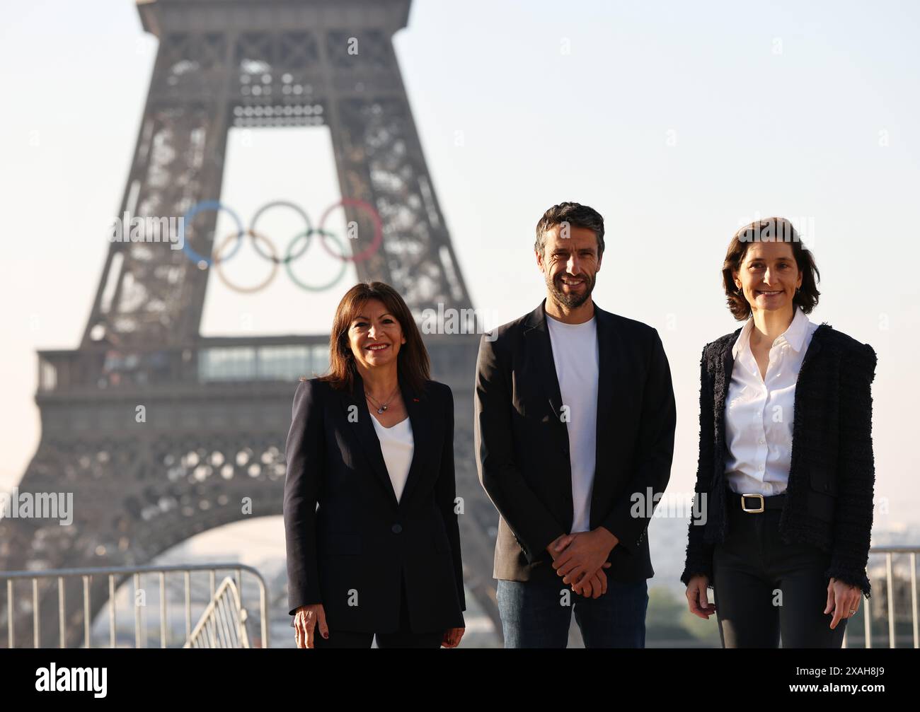 Paris, France. 7th June, 2024. France's Sports Minister Amelie Oudea-Castera (R), President of the Paris 2024 Olympic Games Organizing Committee Tony Estanguet (C) and Paris Mayor Anne Hidalgo pose with the Olympic rings on the Eiffel Tower, in Paris, France, on June 7, 2024. The Olympics rings are unveiled on the Eiffel Tower early in the morning of Friday as the French capital marks 50 days until the start of the upcoming Paris 2024 Olympic Games. Credit: Gao Jing/Xinhua/Alamy Live News Stock Photo