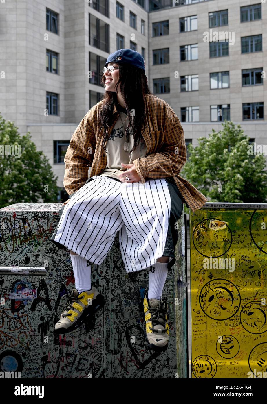 07 June 2024, Berlin The American singer Billie Eilish is sitting on a ledge of a staircase