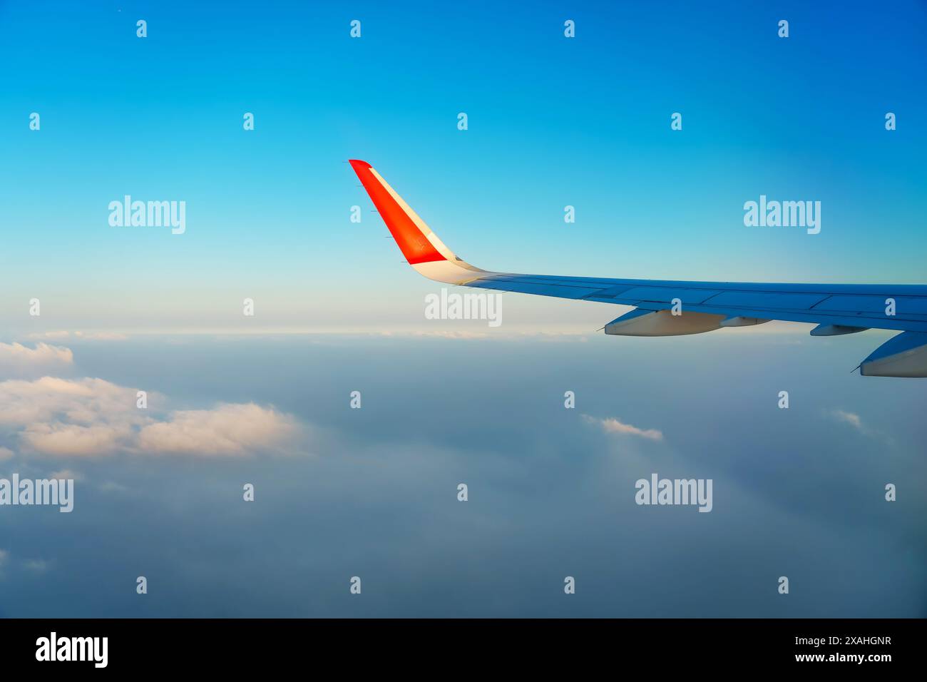 The view from the airplane window to the clouds and sunset. Airplane ...