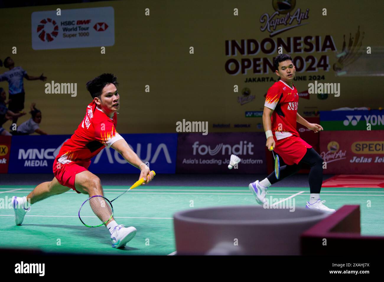 Leo Rolly Carnando (R) and Daniel Marthin of Indonesia in action during the mens doubles match on day three of the Kapal Api Indonesia Open between Go Stock Photo