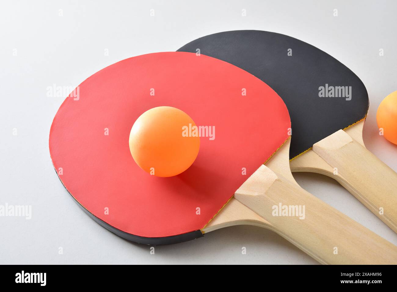 Set of table tennis rackets and two orange balls isolated on white ...