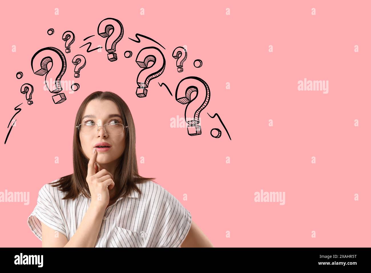 Thoughtful young woman and drawn question marks on pink background ...