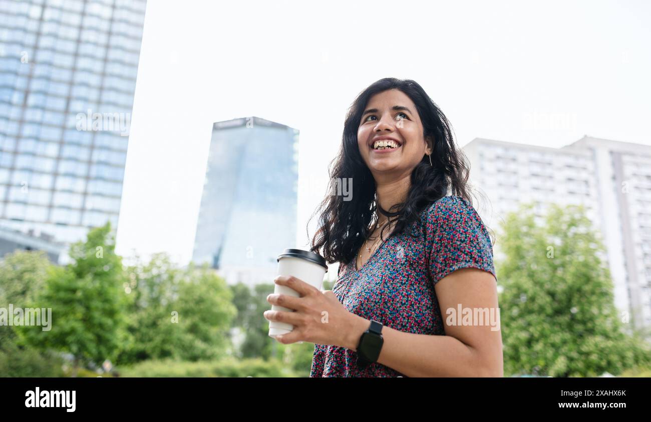 Portrait of a smiling young woman in the city Stock Photo