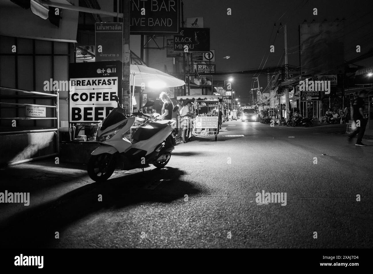 street life with buildings and people in Soi Buakhao of Pattaya district Chonburi in Thailand Asia in monochrome or black and white Stock Photo