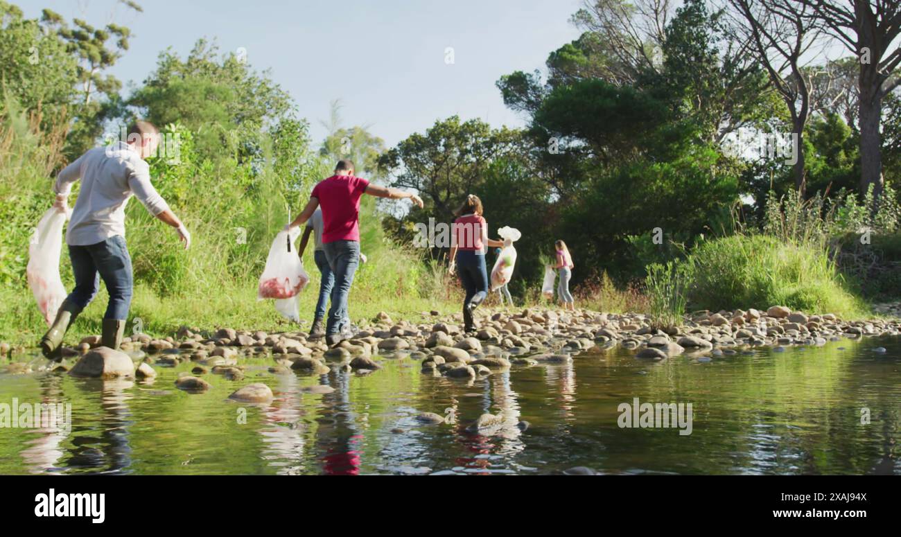 Image of recycling icon over caucasian volunteers cleaning nature Stock ...