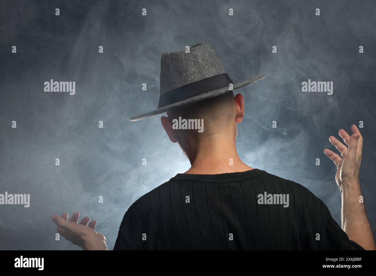 Portrait of a man with a beard and sunglasses and hat with his back to ...