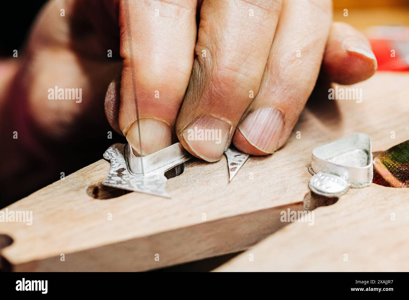 Close up of jewelers hand working with jewelers saw Stock Photo