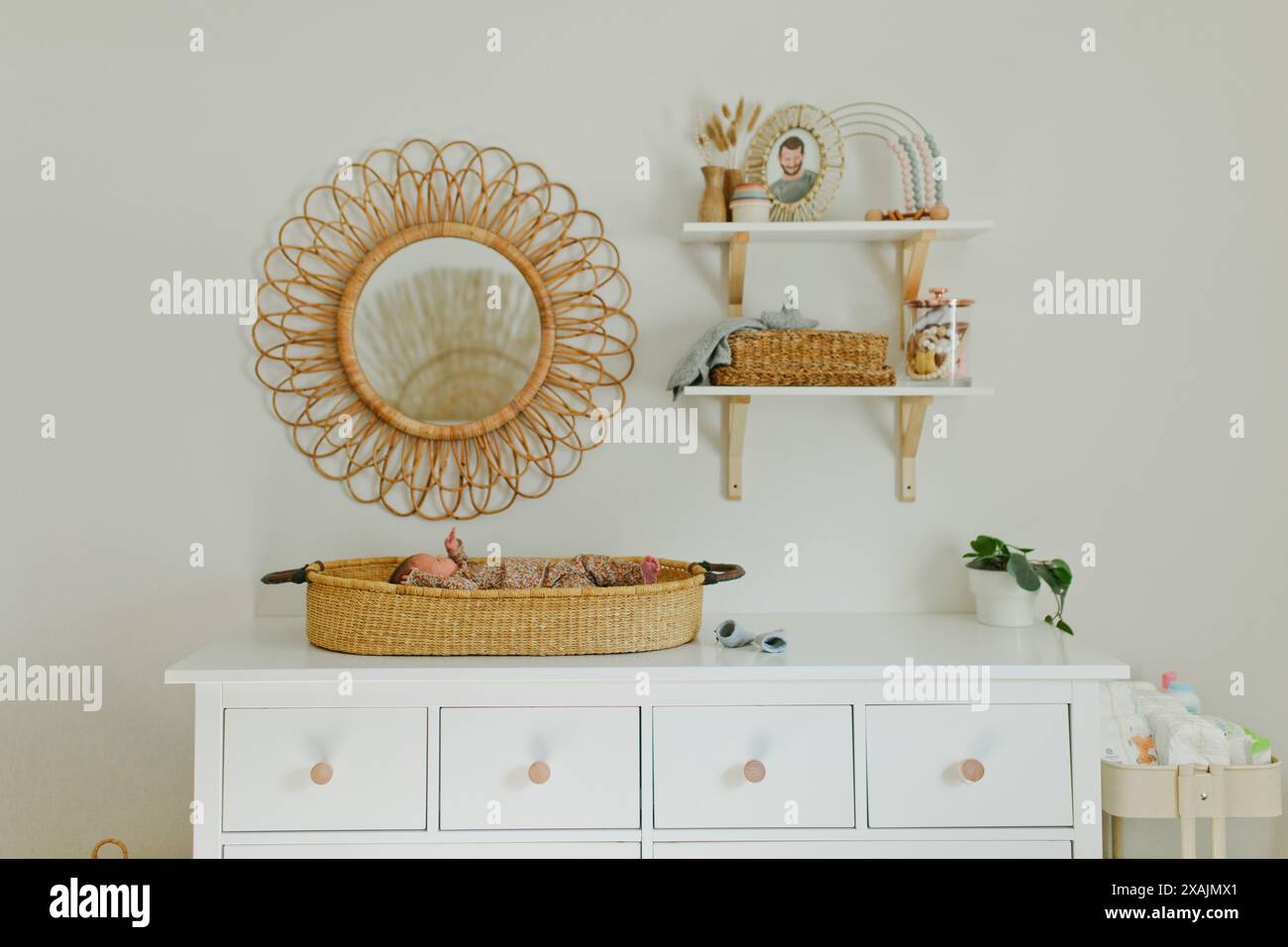 Newborn baby girl lays on changing table in nursery Stock Photo