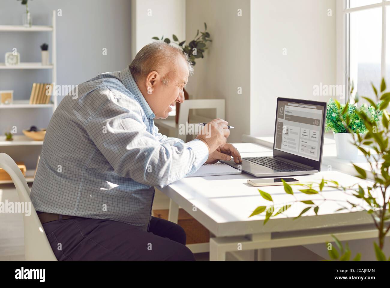Elderly Man Working From Home With Computer Stock Photo
