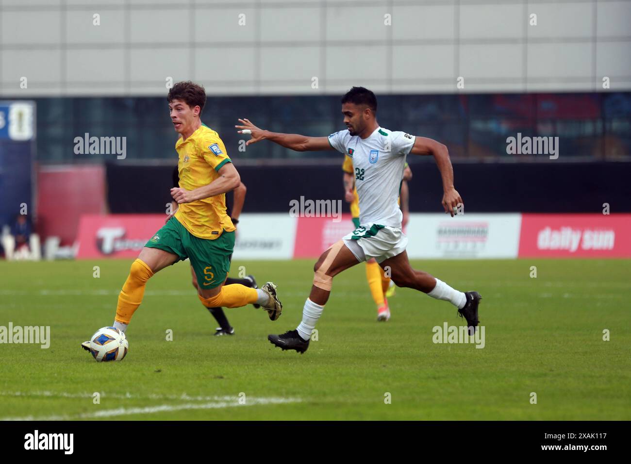 Bangladeshi defender MD Saad Uddin (R)  and Australia defender Jordan Bos during their second leg match of the FIFA World Cup Qualifiers at the Bashun Stock Photo