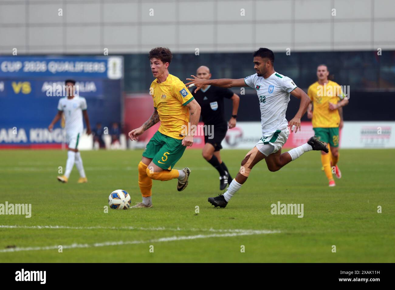 Bangladeshi defender MD Saad Uddin (R)  and Australia defender Jordan Bos during their second leg match of the FIFA World Cup Qualifiers at the Bashun Stock Photo
